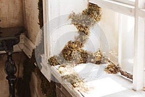 Loft design window sill and brick wall covered with moss