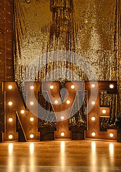 Loft idea for Christmas. Bulb lights on wooden stand letters NYE photo