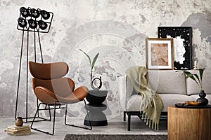 Loft and indiustral interior design of living room interior with mock up poster frame, leather brown armchair, modern black lamp,