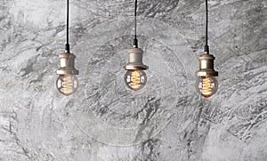 Loft pendant lamps on the background of rough cement plaster.