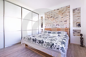 Loft style designed bedroom with double bed, build in wardrobe,