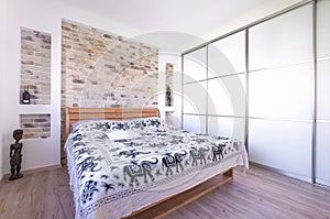 Loft style designed bedroom with double bed, build in wardrobe,