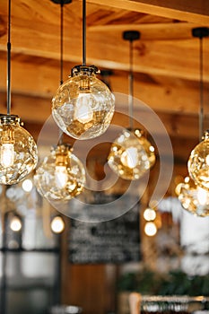 Loft-style luminaires in the interior of a modern cafe. photo