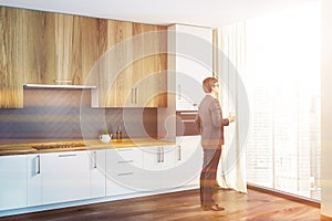 Loft white and gray kitchen corner, man