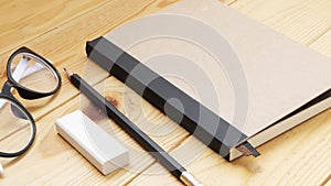 Loft workspace with stationaries on wooden table.