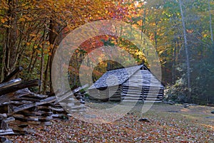 Log barn and split rail fence in mountain pasture