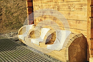 Log bench with 3 places outdoor in sunny day