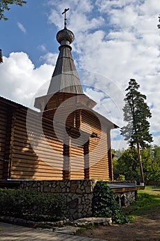 A log cabin angled tower of the temple with a dome