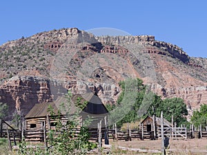 Log cabin and a barn house at Grafton ghost town, Utah, with beautiful red rock formations