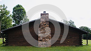 Log Cabin with Cobblestone and Brick Fireplace Chimney