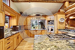 Log cabin kitchen interior design with large storage combination