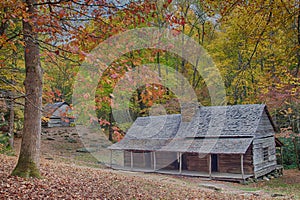 Log cabin and log barn among fall colors