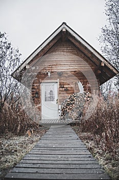 Log cabin in the middle of brown autumn Colors