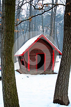 Log cabin in snow woods