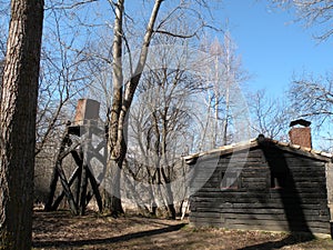 Log cabin and water tank photo