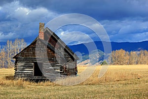 Log cabin in western montana meadow photo