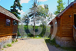 Log cabins in the woods by a lake