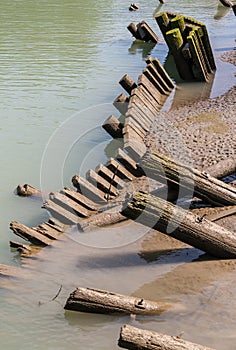 Log Piles Leaning into Water