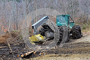 Log skidder parked on muddy skid trail