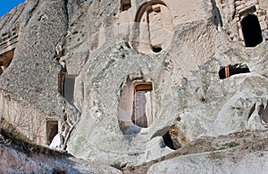 Log in unusual house, carved in the rock, in the mountains