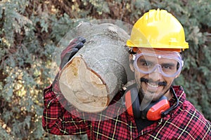 Logger holding heavy trunk in the forest photo