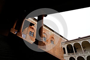 Loggia with columns and brick wall. Cortile del Broletto or Novara town hall