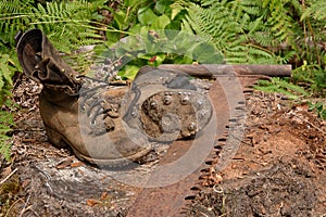 Logging boots and handsaw