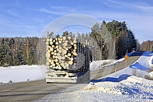 Logging Truck Transports Load of Logs in Winter