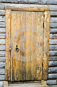 Loghouse wooden door with a padlock