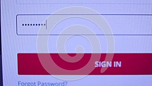Login web page closeup. Entering password and clicking the button sign in on computer screen