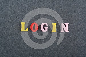 LOGIN word on black board background composed from colorful abc alphabet block wooden letters, copy space for ad text. Learning