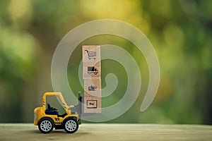 Logistic network distribution and cargo freight concept: Mini fork-lift truck moves a pallet with wooden block with icon. depicts