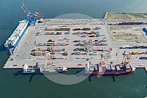 Logistic port, cargo ships and containers, military equipment. Drone view