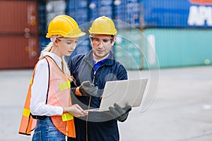 Logistic shipping worker team work working in shipping port cargo containers for export and import goods monitor with laptop