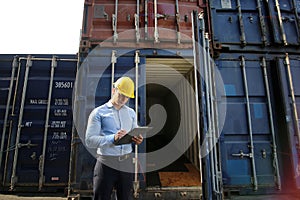 Logistic transportation concept. Foreman control loading Containers box from Cargo freight ship for import export.