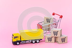Logistics, and delivery service - Cargo truck, Red shopping cart and paper cartons or parcel with a shopping cart logo on Pink