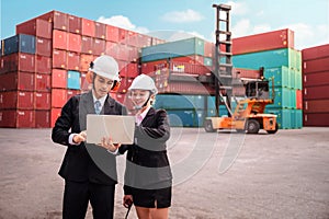 Logistics engineer control at the port, loading containers for trucks export and importing logistic concept