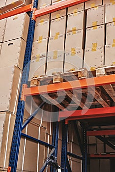 Logistics through innovation, dedication, and technology. Stack of carton boxes on pallet ready for transportation
