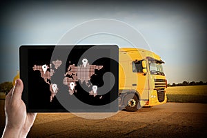 Logistics. Man using tablet with world map on screen against truck