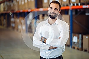 Logistics manager posing in warehouse