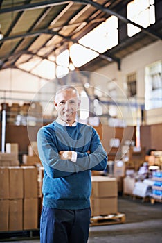 Logistics is our business. Portrait of a mature man standing in a distribution warehouse.