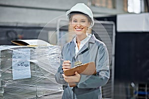 Logistics, portrait and woman in warehouse with clipboard for quality control, inventory or freight distribution