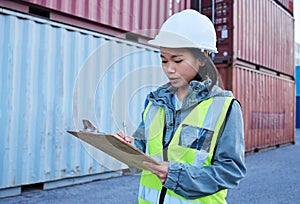 Logistics, shipping and asian woman engineer writing checklist report for inspection or delivery control of cargo