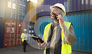 Logistics, shipping and construction worker on the phone with tablet in shipyard. Transportation engineer on smartphone