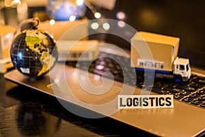 Logistics Supply Chain Challenges - still life logistics business concept with laptop, phone, mini shipping cartons