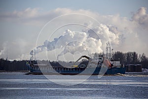 Logistics and transportation Cargo ship with ports crane bridge coming in port