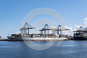 Logistics and transportation of Container Cargo ship and Cargo plane with working crane bridge in shipyard