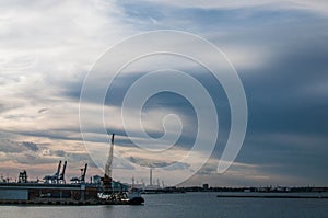 Logistics and transportation of International Container ship in the ocean at twilight sky