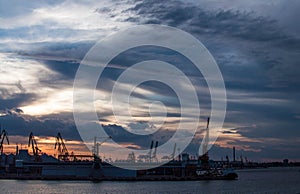 Logistics and transportation of International Container ship in the ocean at twilight sky