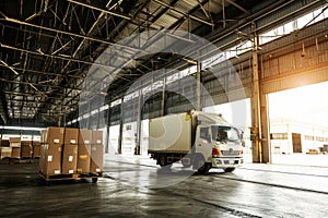 Logistics and transportation. White truck in the warehouse with boxes. for advertising